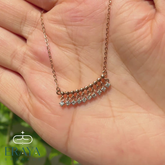 Video: 360° hands-on view of dangling diamond bar necklace showing lab-grown diamonds and rose gold chain